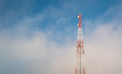 Low angle view of communications tower against sky