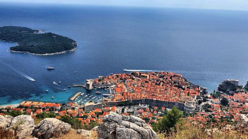 High angle view of townscape by sea