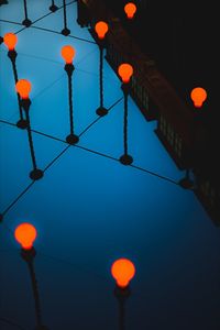 High angle view of illuminated lighting equipment hanging from wall