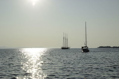 Scenic view of boats in sea against clear sky