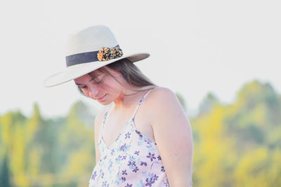 Portrait of woman against hat against clear sky