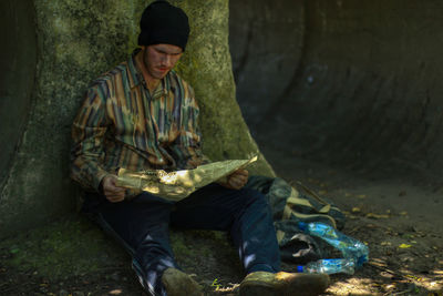 Young man sitting outdoors