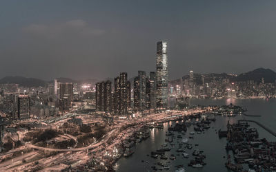 High angle view of illuminated city buildings against sky