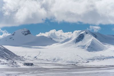 Scenic view of snowcapped mountains against sky