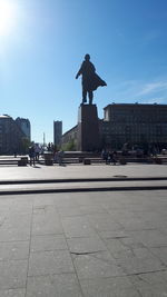 People walking on street in city against sky