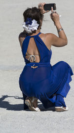 Rear view of woman sitting on bench