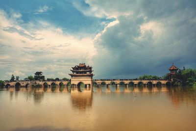 View of bridge over river against cloudy sky