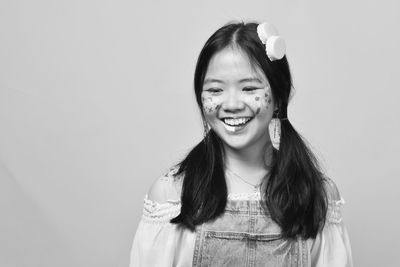 Portrait of smiling girl against white background