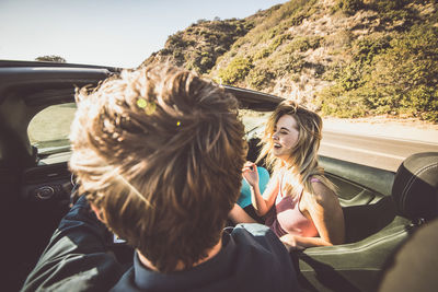 Rear view of couple sitting in car