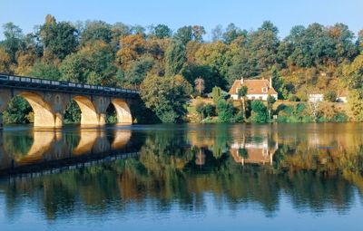 Arch bridge over river against sky