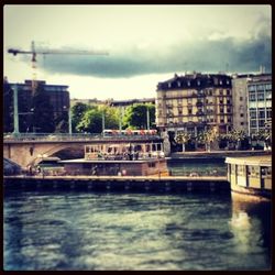 Bridge over river against cloudy sky