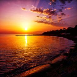Scenic view of sea against romantic sky at sunset