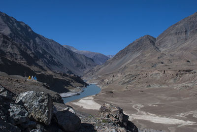 Scenic view of mountains against clear blue sky