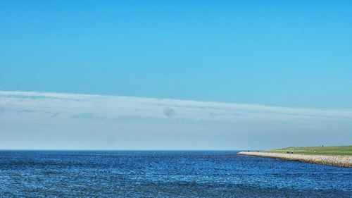 Scenic view of sea against blue sky
