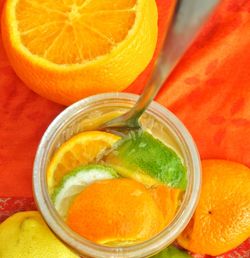 High angle view close-up of citrus fruit in glass with utensil