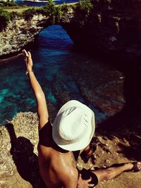 High angle view of woman on rock in sea