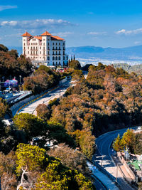 High angle view of townscape by sea against sky