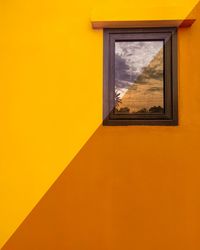 Yellow window of orange building