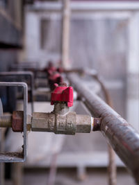 Close-up of padlock on metal pipe