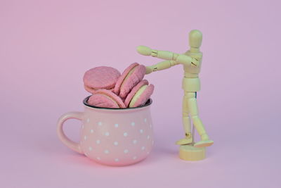 Close-up of figurine on table against white background