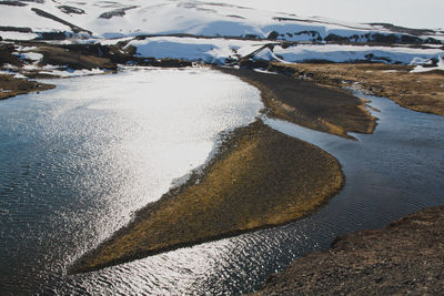 Frozen lake against mountain during winter