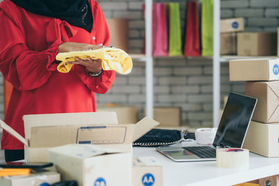 Midsection of woman working at table