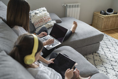 High angle view of woman reading book at home