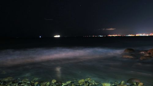Scenic view of illuminated lake at night