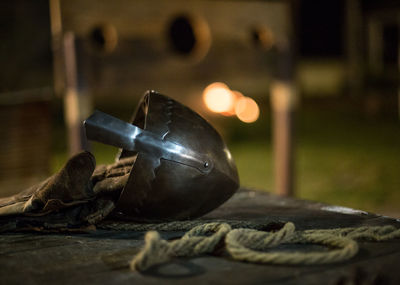 Close-up of old medieval helmet on wooden table