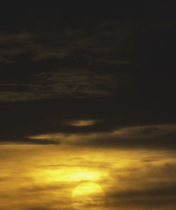 Low angle view of storm clouds in sky during sunset