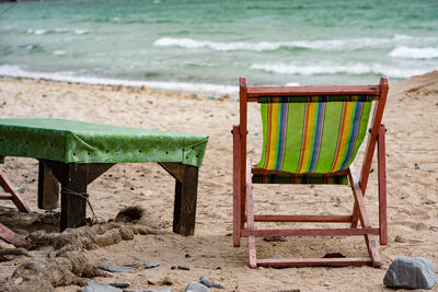 Empty chair at sandy beach