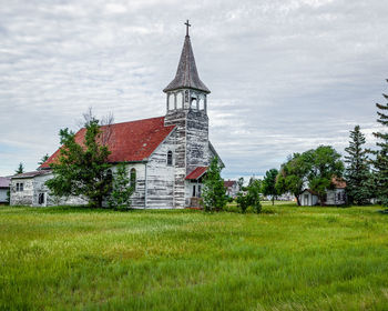 Church on field against sky