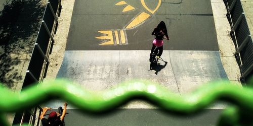 High angle view of people riding bicycle on road