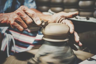 Potter shaping clay at workshop