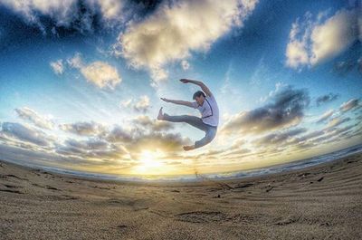 Person paragliding over sea