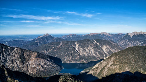 Scenic view of mountains against blue sky