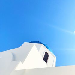 Low angle view of white building against clear blue sky