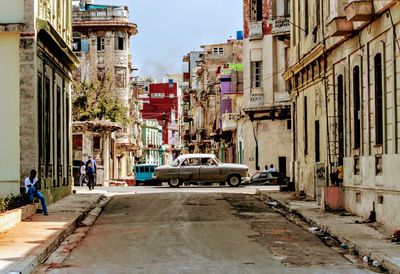 City street amidst buildings against sky