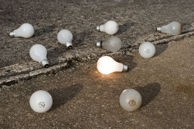 High angle view of light bulbs on footpath