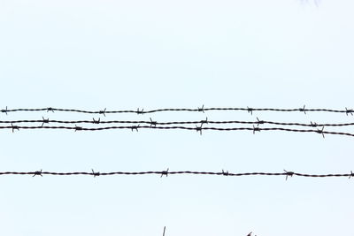 Barbed wire against clear sky