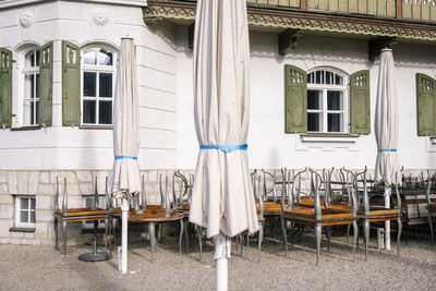 Empty chairs and tables at outdoors cafe