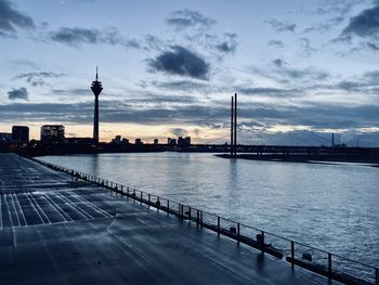 View of bridge over river against cloudy sky