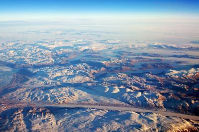 Aerial view of snowcapped mountains against sky