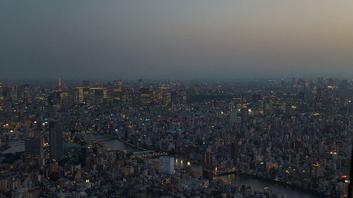 High angle view of illuminated city buildings against sky