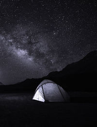 Low angle view of tent against sky at night