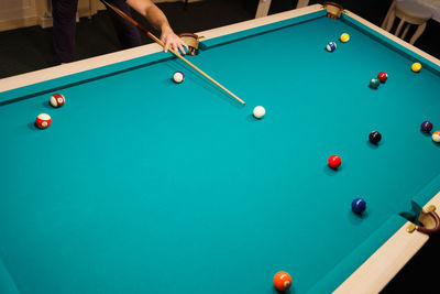 Cropped hand playing pool