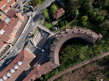 High angle view of road amidst trees and buildings in city