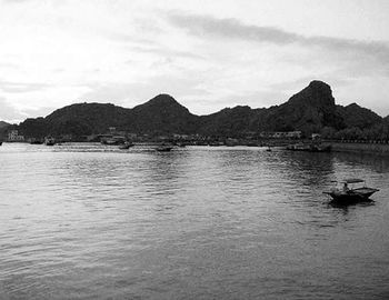 Boats in lake with mountains in background