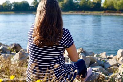 Rear view of woman looking at lake