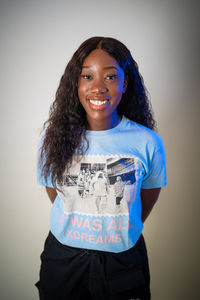 Portrait of a smiling young woman against white background